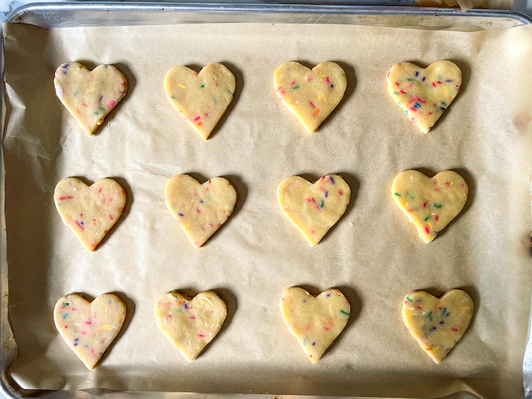 Unbaked heart cookies on a tray