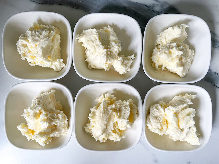 Six dishes of white buttercream