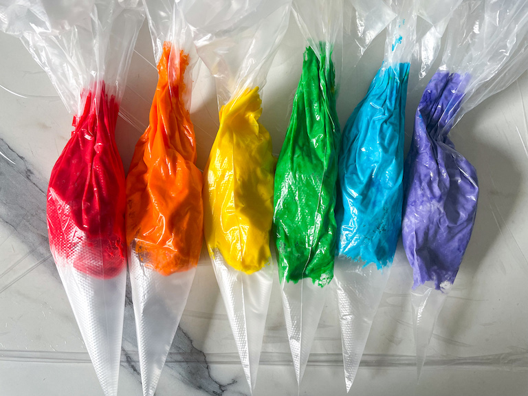 Piping bags of rainbow buttercream