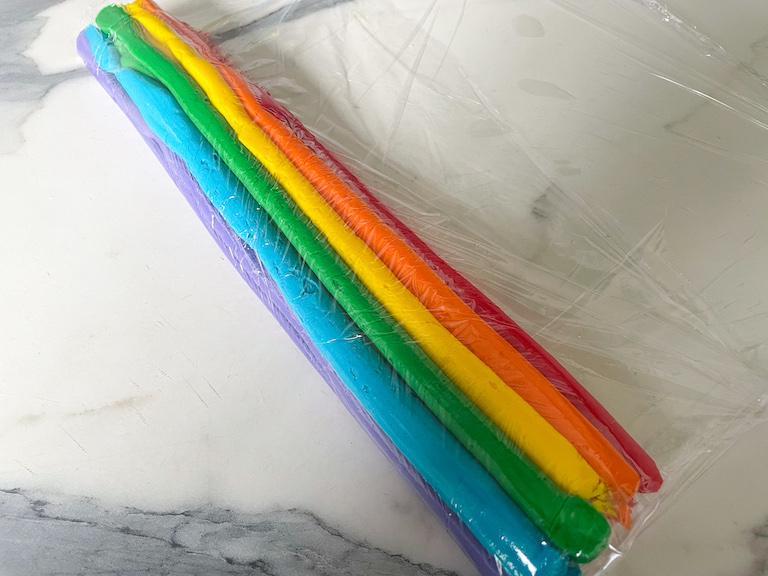 clingfilm with rainbow buttercream
