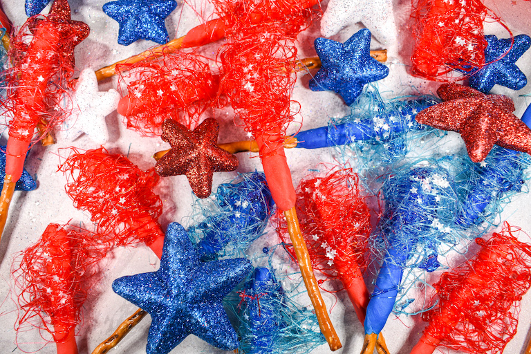 Red and blue sparklers along with glitter stars