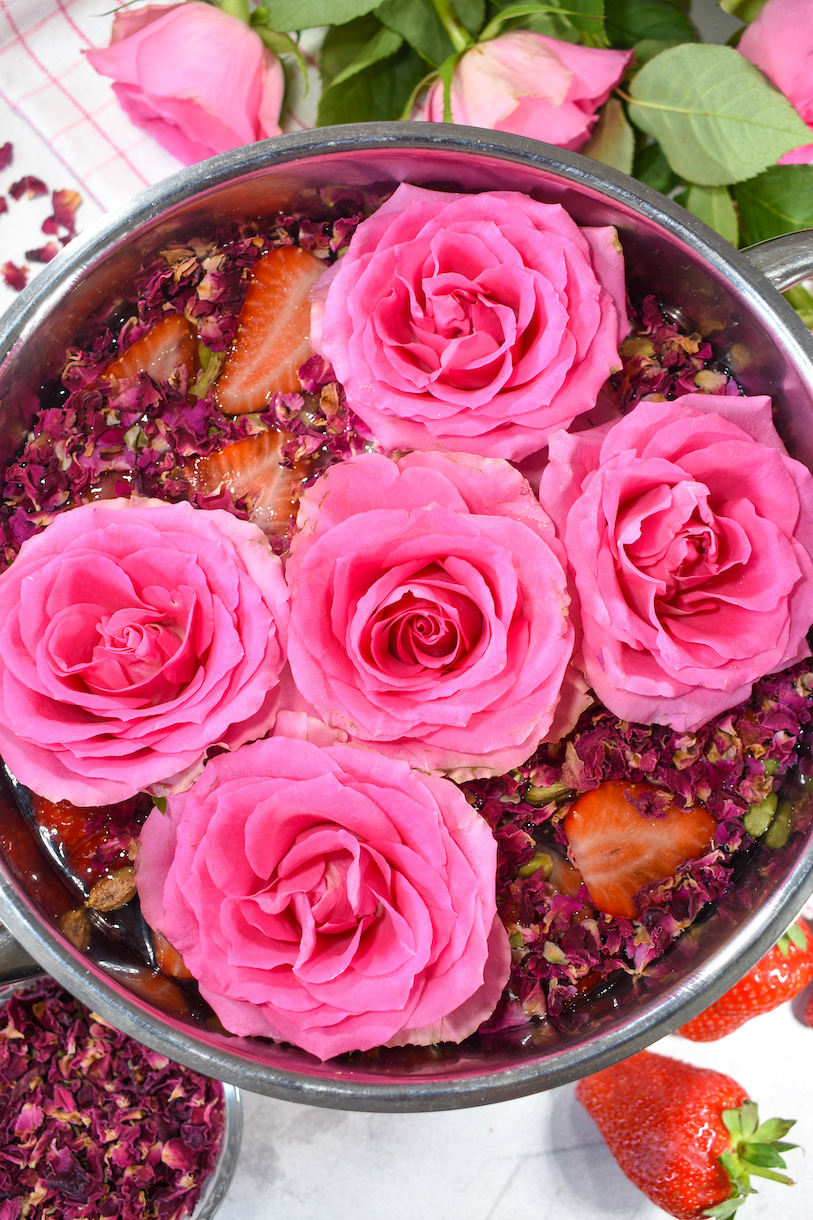 A stovetop potpourri of fresh roses, dried roses, and sliced strawberries
