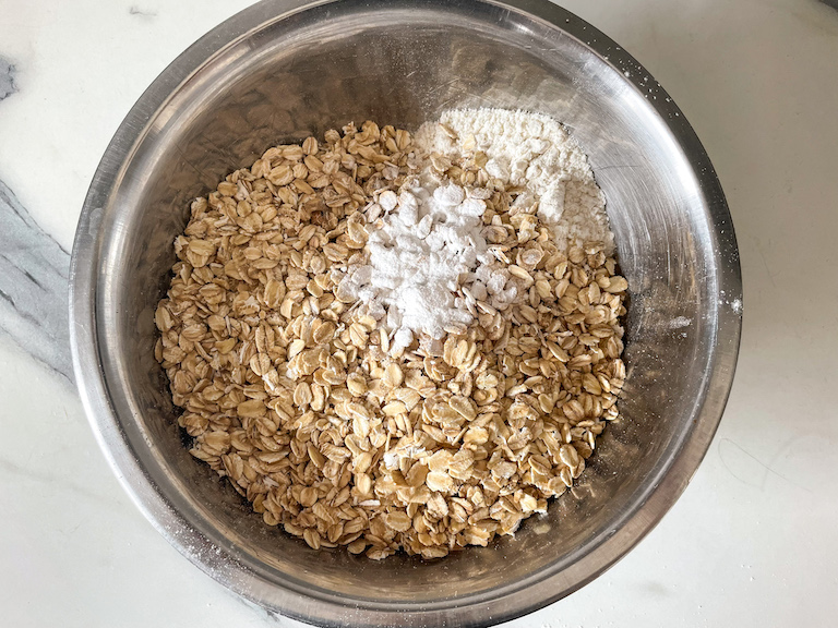 Oats and other dry ingredients in a metal bowl