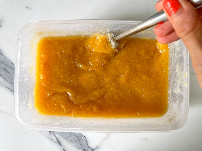 Scraping peach granita with a fork