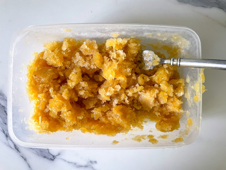 Peach granita in a rectangular plastic container