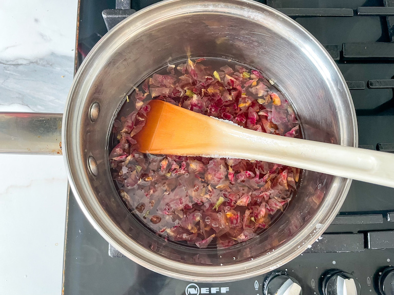 Spoon in a saucepan of water and rose petals