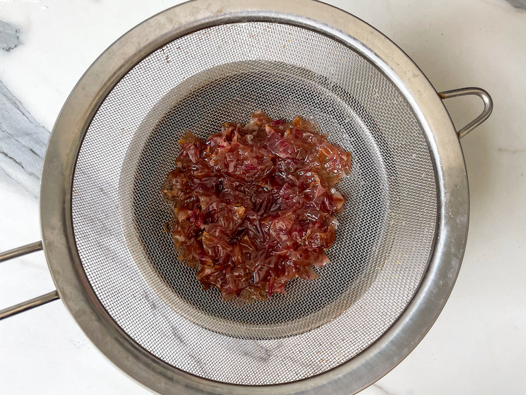 Rose petals in a fine mesh strainer