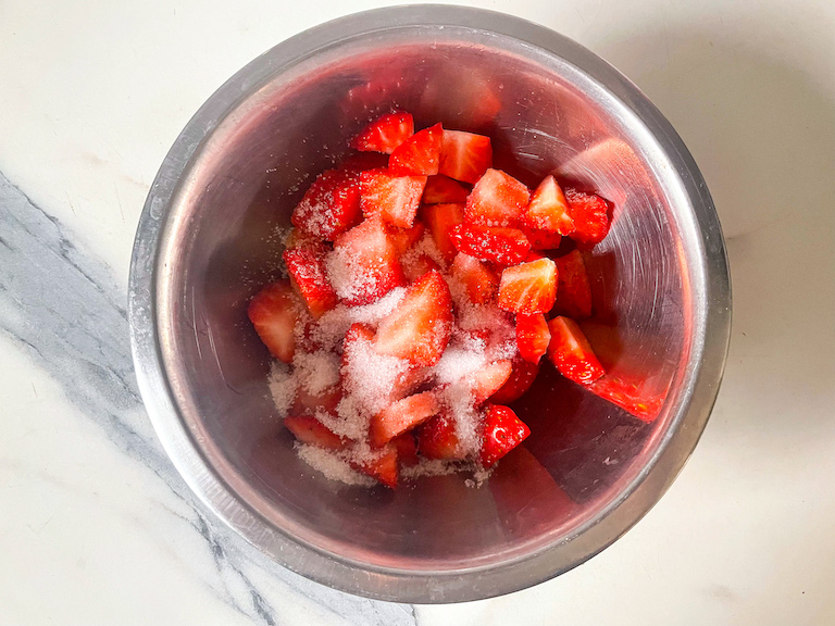 Bowl of strawberries and sugar