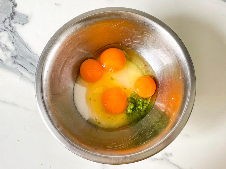 Eggs, sugar, lime zest in a bowl
