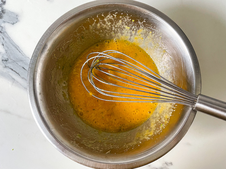 Whisk in a bowl with eggs