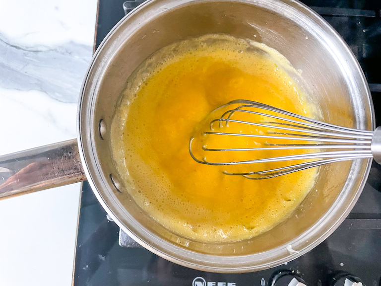 Lime curd in saucepan with whisk