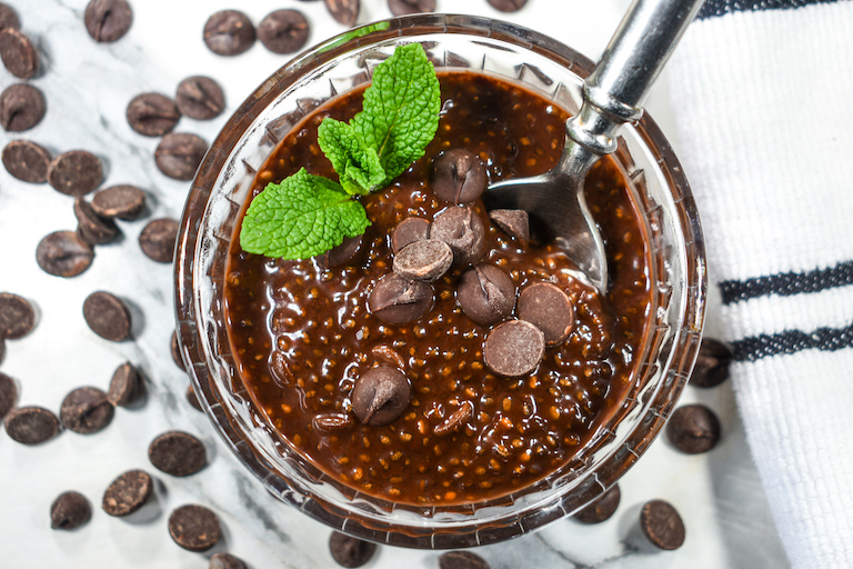 A dish of chocolate chia pudding with a spoon