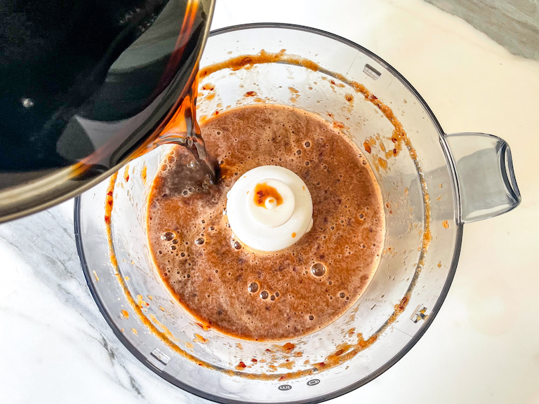 pouring cola reduction into blitzed cherries