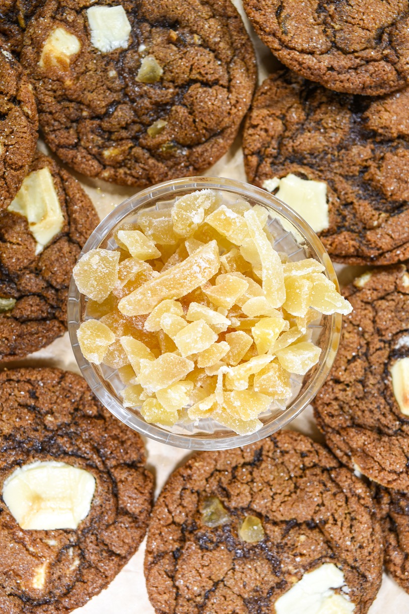 A bowl of candied ginger surrounded by chai cookies