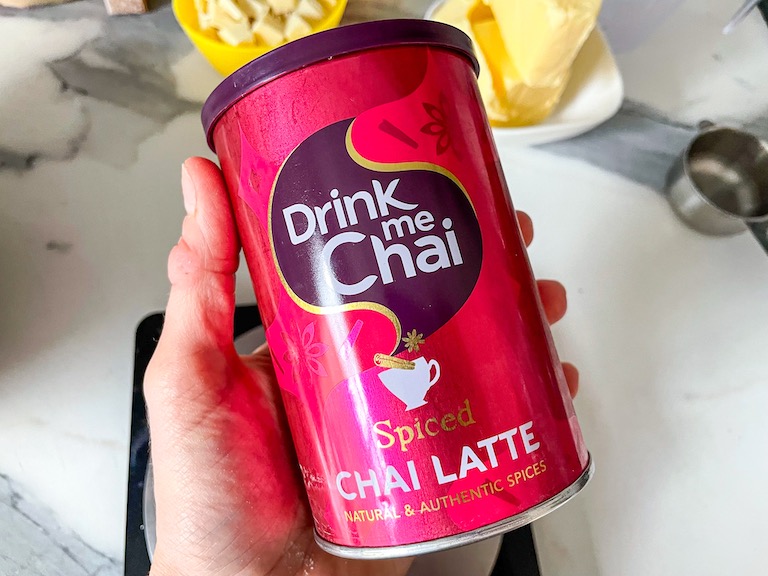 Hand holding a can of powdered chai