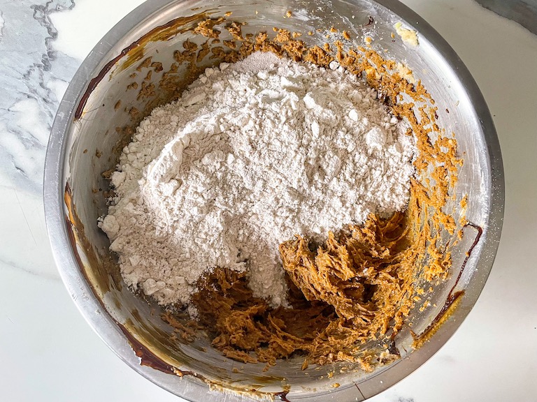 Cookie dough and dry ingredients in a bowl