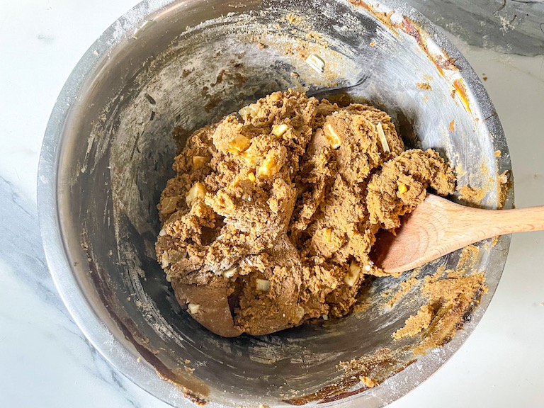 Cookie dough in a bowl with a wooden spoon