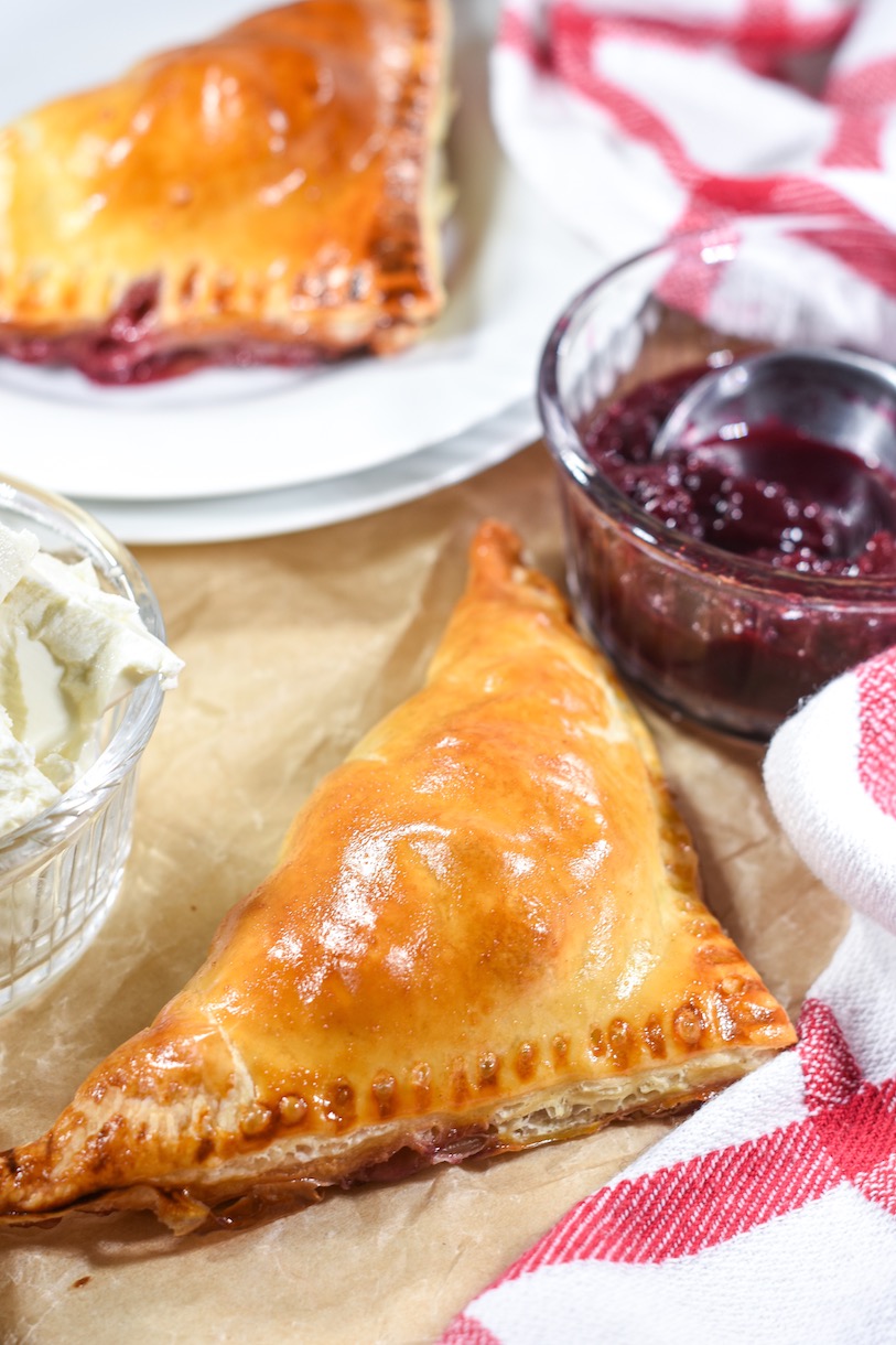 Puff pastry triangle with a dish of cherry compote