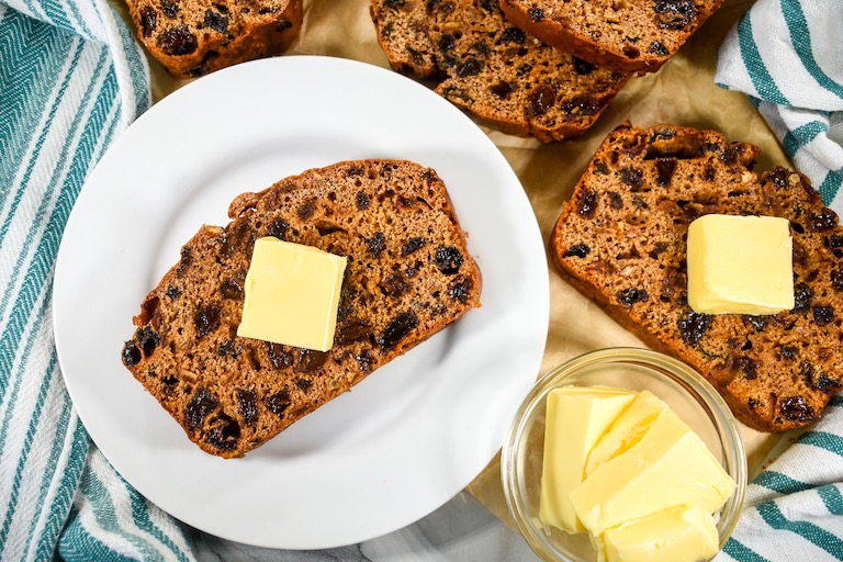 Slices of bara brith with pats of butter on top