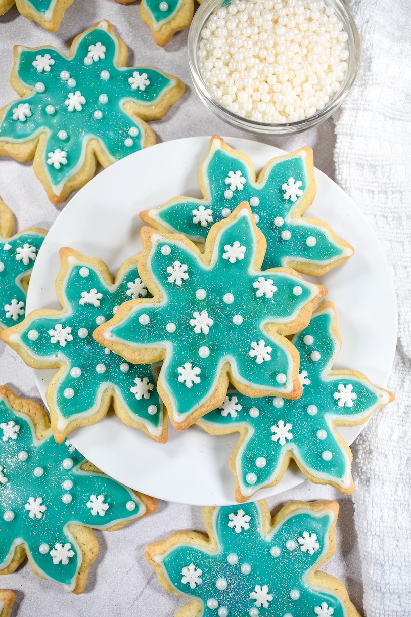snowflake sugar cookies on a white plate