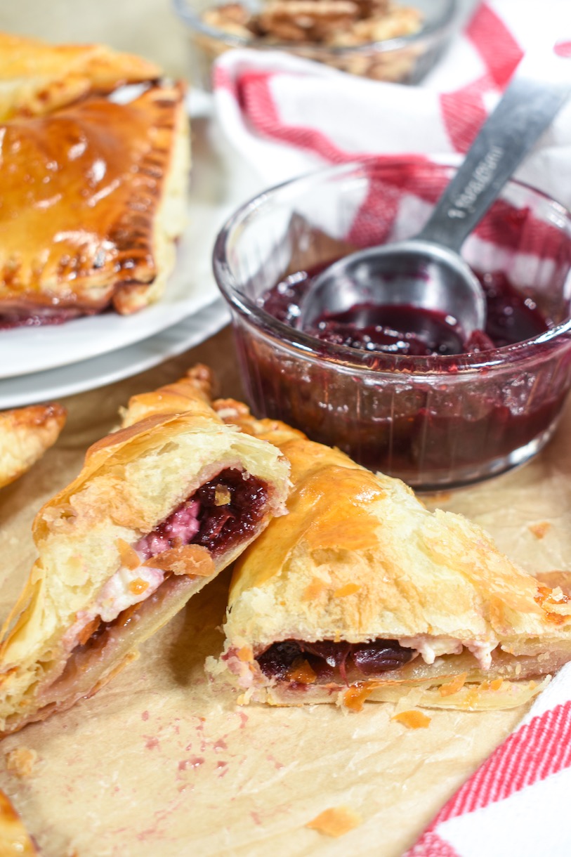 A sliced pastry with a dish of cherry compote