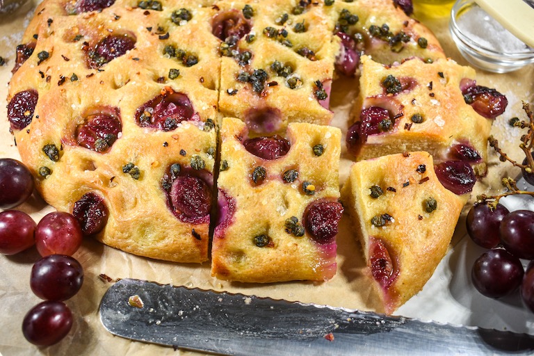 Sliced focaccia bread with red grapes