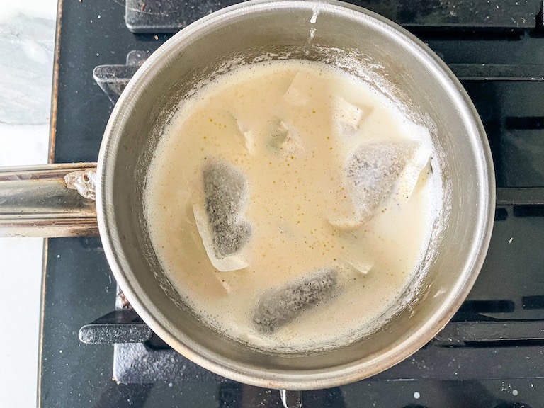 Tea bags in a saucepan of cream