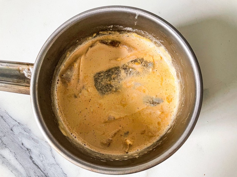 Tea bags steeping in a saucepan of cream