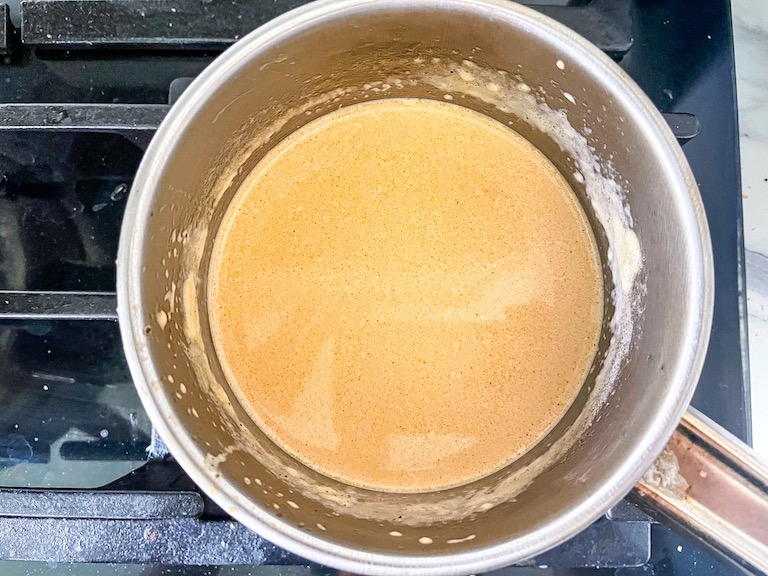 Chai infused cream in a saucepan