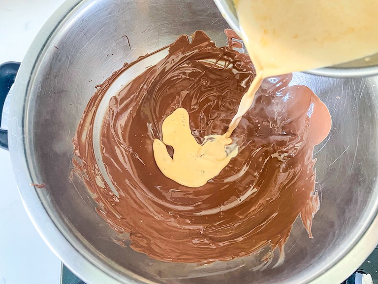 pouring cream into melted chocolate