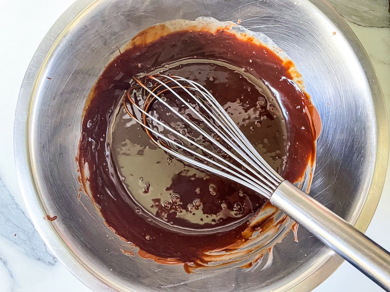 Chocolate ganache and whisk in a bowl