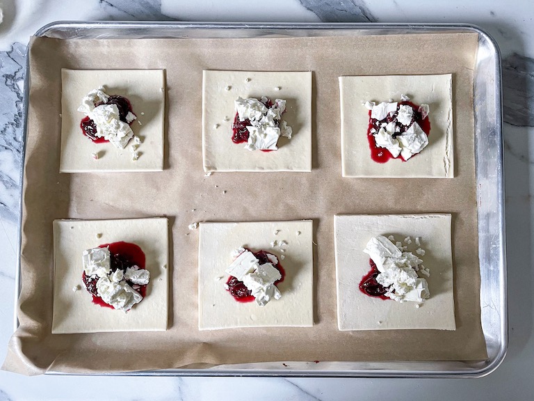 Feta and cherries on squares of puff pastry