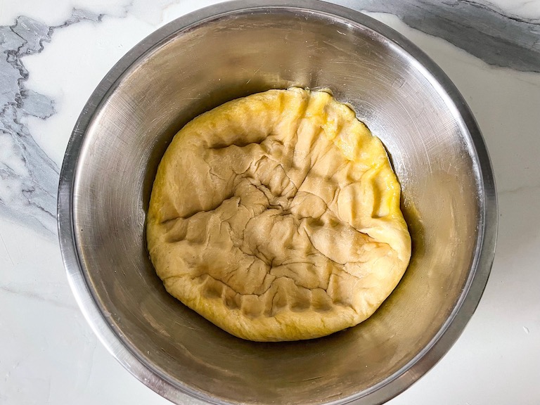 punched down focaccia dough in a bowl