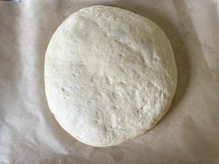 Risen focaccia dough on parchment