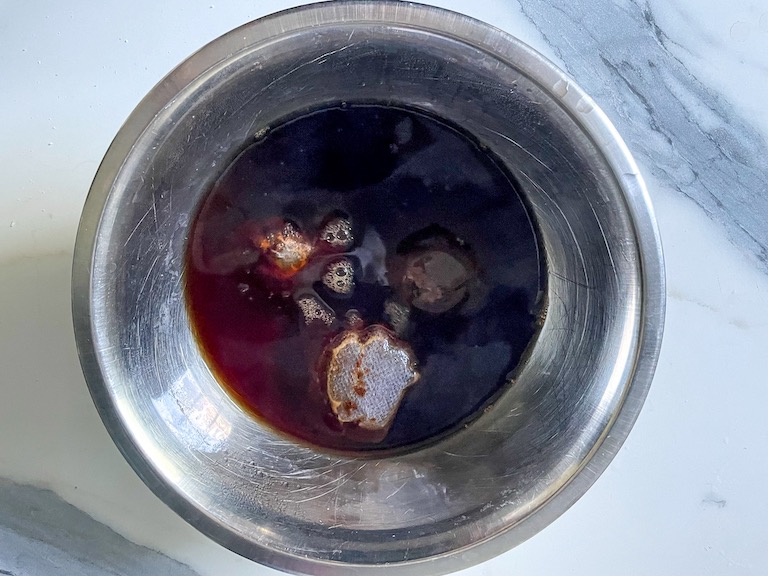 Black tea in a metal bowl