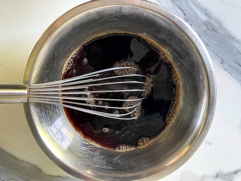 Whisk in a bowl of black tea