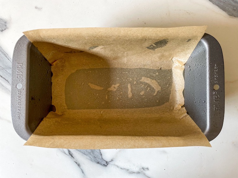 Loaf pan lined with a sheet of parchment