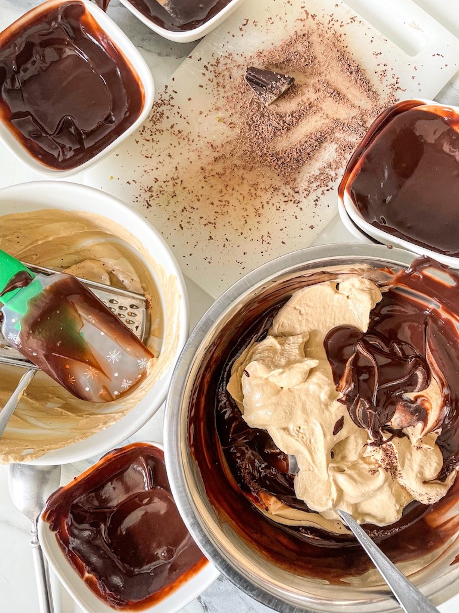 Bowls of chocolate pudding, coffee whipped cream, and shaved chocolate