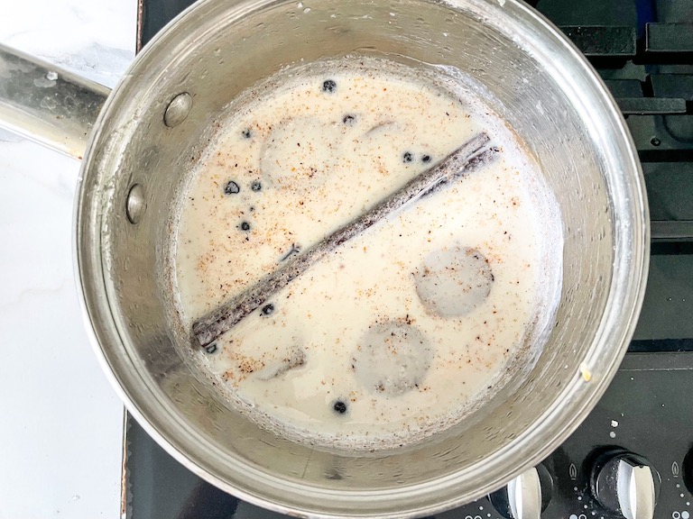 Infusing spices into whole milk in a pan on the stovetop