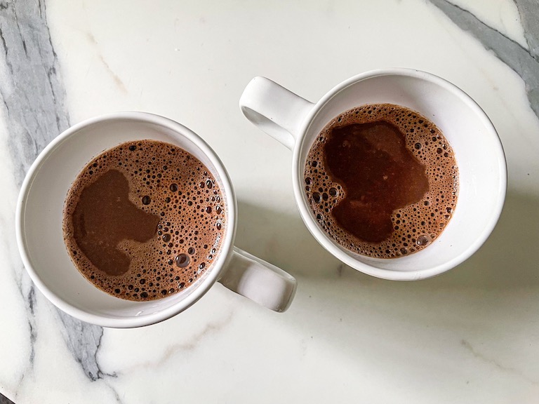 Two mugs of gingerbread hot chocolate