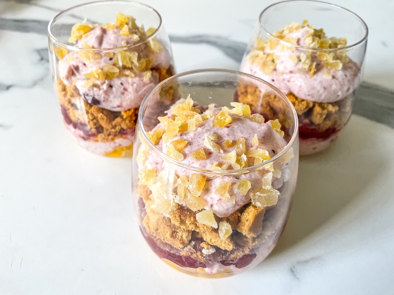 Cranberry and orange parfaits assembled in wine glasses