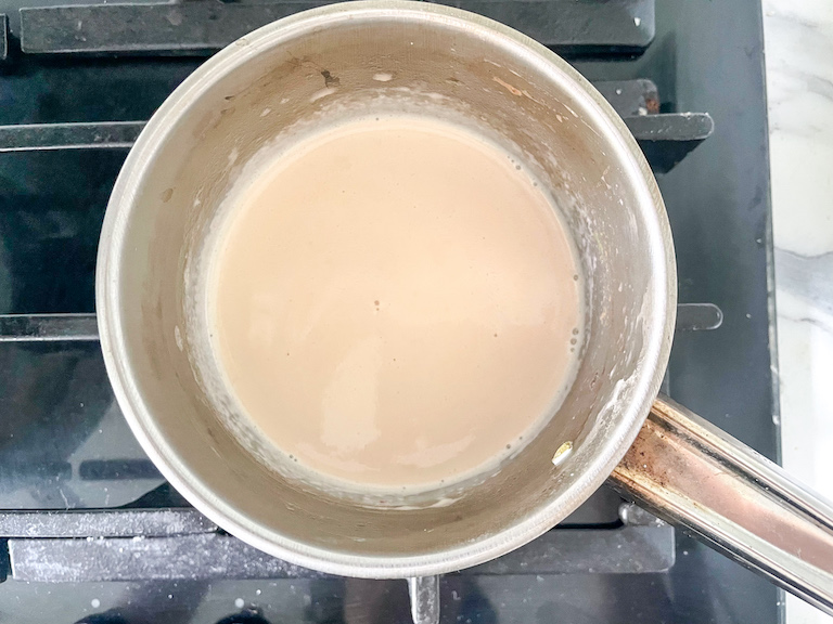 Saucepan of cream on a stovetop