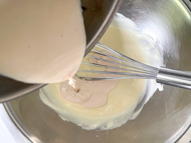 Pouring rose infused cream into white chocolate