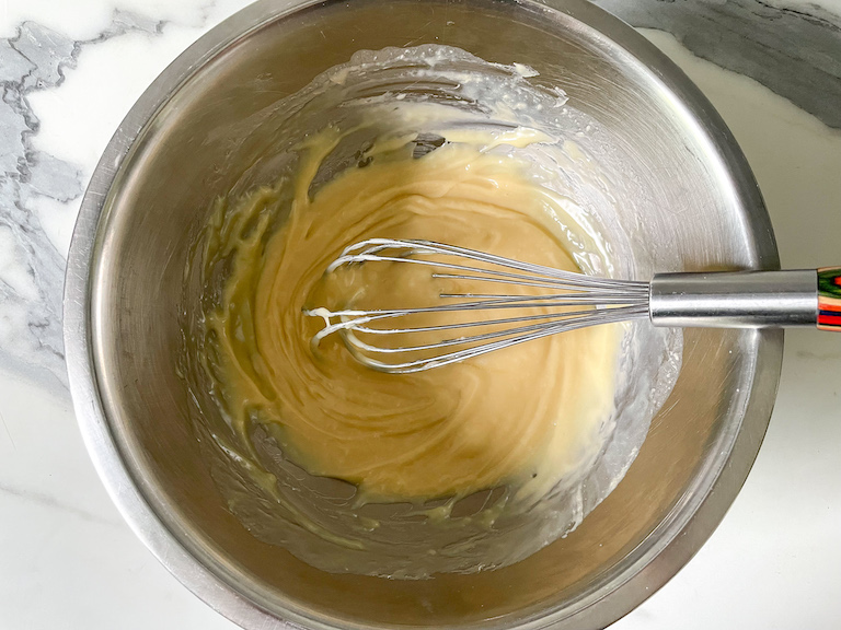 White chocolate and whisk in a bowl