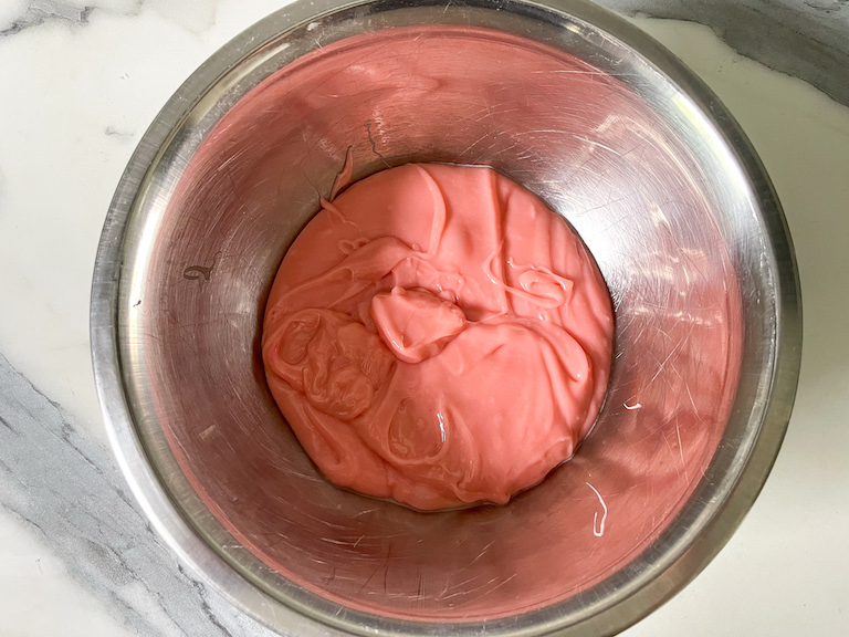 Rose and white chocolate ganache in a bowl