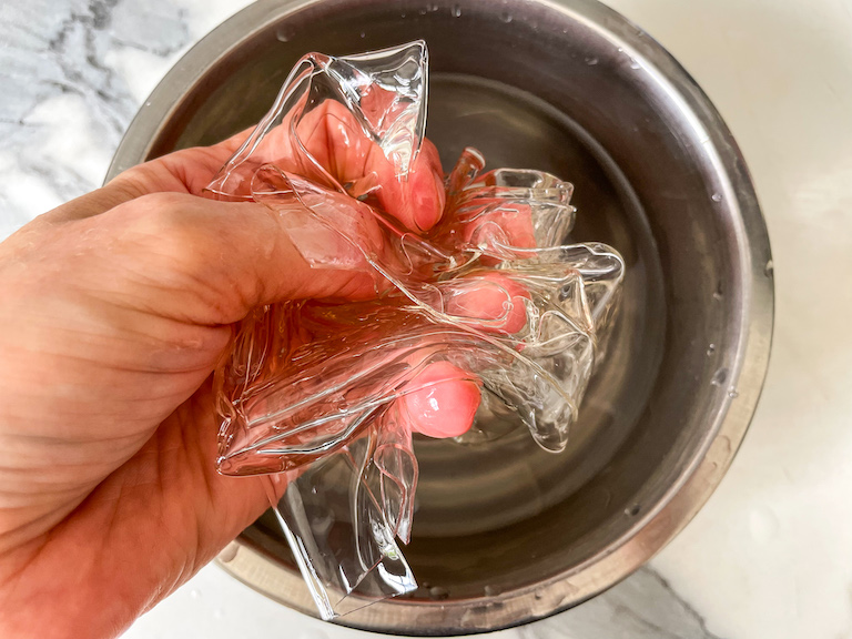 Hand squeezing soaked gelatin leaves