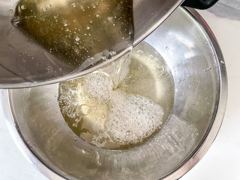 Pouring hot sugar into soaked gelatin