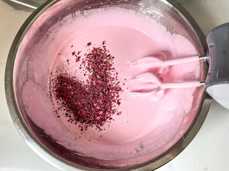 Adding dried ground rose petals to marshmallow mixture