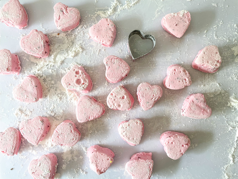 Heart shaped marshmallows on a cutting board