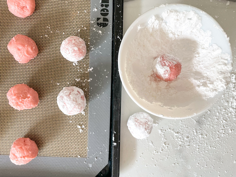 Rolling truffles in powdered sugar